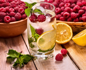 Wooden boards glass with raspberry ice cubes alcohol cocktail . Cocktail three hundred and twenty six cocktail raspberry mojito with raspberry bowl.