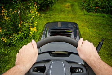Man driving a mower tractor - point of view