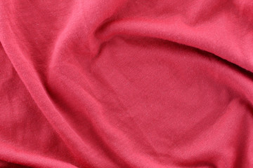 Closeup of rippled red cotton fabric.