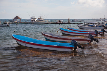 Fishing motor boats moored to tropical beach