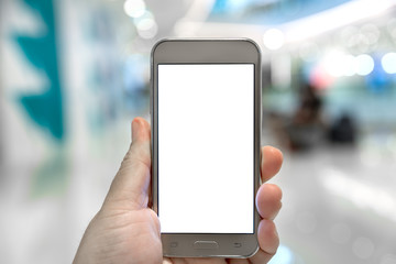 Hand touch screen on the smart phone in shopping mall.