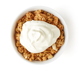 Bowl of whole grain muesli with yogurt isolated on white, from a