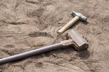 Hammer and sledgehammer on sand