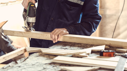 Sawing wooden log by fretsaw