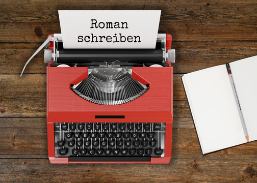 Schreibmaschine mit ROMAN SCHREIBEN-Text und Notizbuch auf Holztisch 