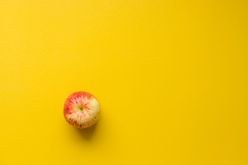 Apple on yellow background