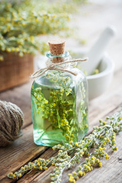 Bottle of absinth or tincture of tarragon healthy herbs, absinth