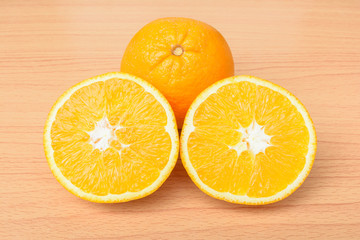 Sliced orange on wood table background