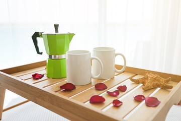 Breakfast tray with coffee on bed decorated roses