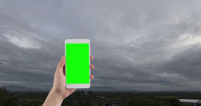 Hand Holding Green Screen Mobile Phone For Taking Photo Of Landscape Of Hill Mountain With Fog In Evening Before Sunset (time Lapse)