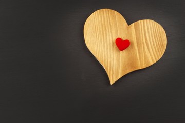 Wooden heart on a dark background. Valentine cards.
