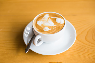 White glass of hot coffee latte art