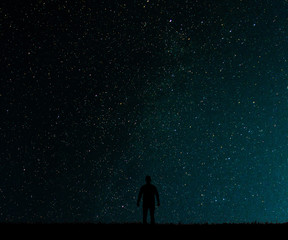 Obraz premium Silhouette of man on a background stars.