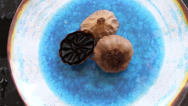 Black garlic on blu plate