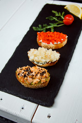 Small canape, crostini with grilled baguette with salmon, pear and sweet peppers. Delicious appetizer