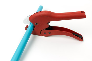 red scissors for cutting plastic pipe on white background.