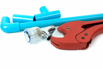 red scissors for cutting plastic pipe and valve on white backgro