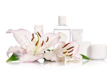 cosmetic set for skin care on a white background with lily flowe