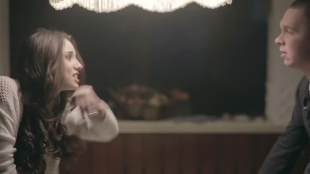Family quarrel. A man and a woman shouting at each other in the kitchen