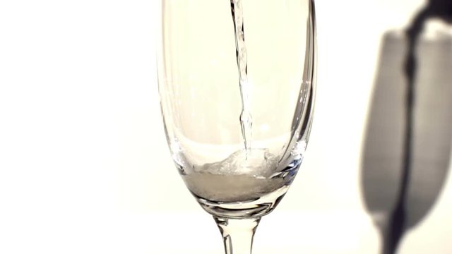 Champagne poured into tall glass slow motion