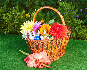 Fototapeta na wymiar Pink Gladiolus near Easter basket with flowers and eggs