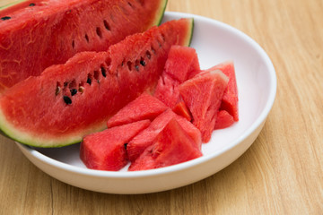 slices of fresh organic watermelon on wood table