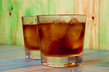 Glass of whiskey on a abstract wooden table