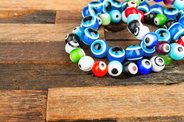 Beads jewelery on wooden background. Macro shot.