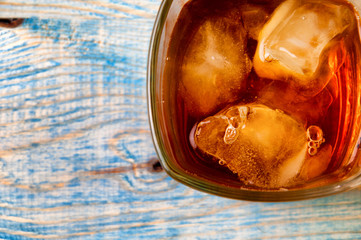 Glass of whiskey on a abstract wooden table