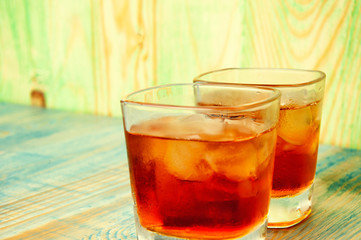 Glass of whiskey on a abstract wooden table
