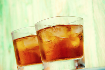 Glass of whiskey on a abstract wooden table
