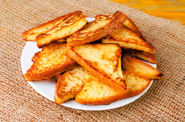 Delicious fried toast on a white plate.