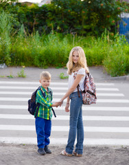 Children stand near a pedestrian crossing