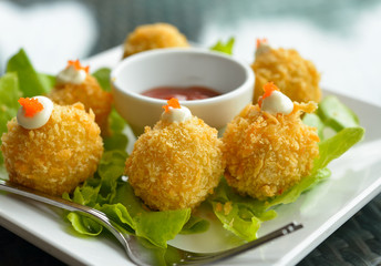 potato croquettes with lettuce on white plate