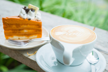 Hot Latte and Thai Tea Cake  on wooden desk