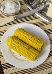 Boiled sweet corn on a white plate.