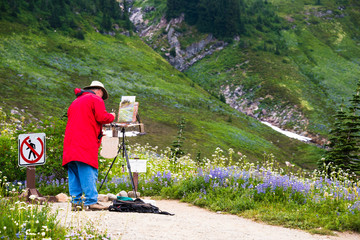 Senior Male Artist Painting on Easel Mountains & WIldflowers en Plein Air
