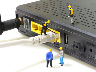 Technicians connecting network cable to router