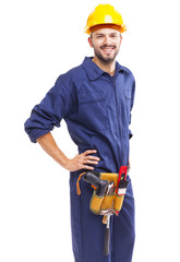 Worker with tool belt standing smiling on white background