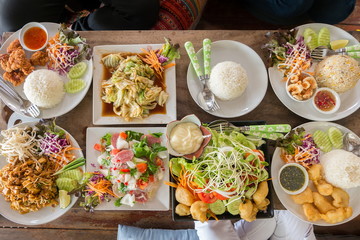 Top view of friends having lunch with various food