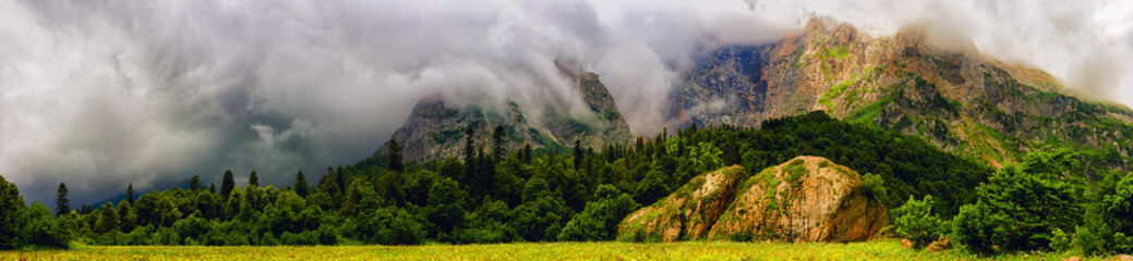 Mountain panorama, forest and clouds.
