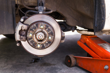 Naklejka premium Car jack to lifting the car for replace wheel and repair at gara