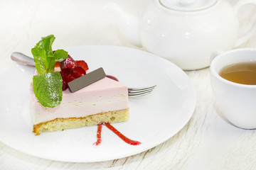 dessert, a piece of cake on the table with a cup of tea