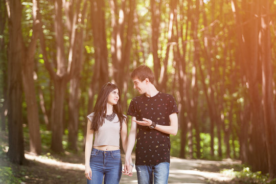 Couple walking and smiling each other with a soft light leack fr