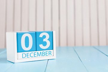 December 3rd. Day 3 of month, calendar on wooden workplace background. Winter time. Empty space for text