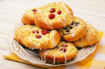Fresh yeast buns with cheese and berries.