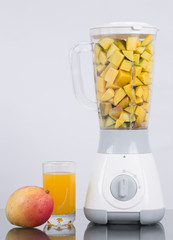 Blender with fruit on white background