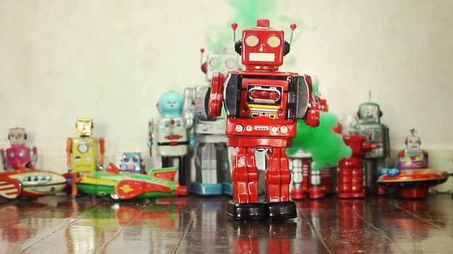 retro red robot toy walks into frame with green smoke 