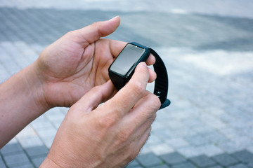 Man using smart watch outdoors