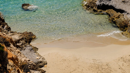 Crystal sea water with waves mooving on the sand beach.